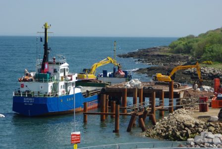 May 2016: Burhou 1 unloads boulders at the temporary pier next to the existing linkspan access road -- copyright Eric Schofield